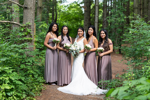 Kristina poses with her bridal party wearing Henkaa Convertible Dresses the best bridesmaid dresses.