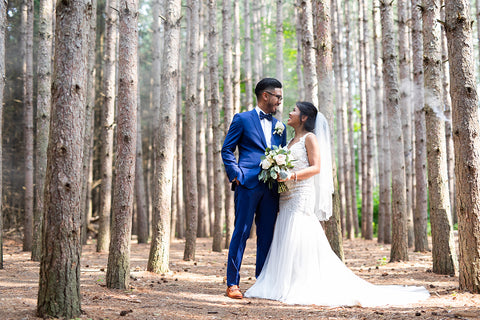 Kristina and Remar pose for their wedding portraits in the forest.