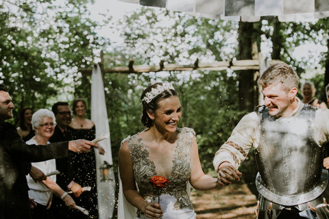 The Medieval themed wedding ceremony took place in Caledon Ontario in Alex Melniks parents forest. This wedding was featured on the Henkaa infinity dress blog.