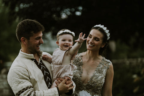 Alex, Lauren and Mars Melnik share an intimate moment at their wedding wearing traditional medieval clothing for their medieval themed wedding featured on the Henkaa infinity dress blog.