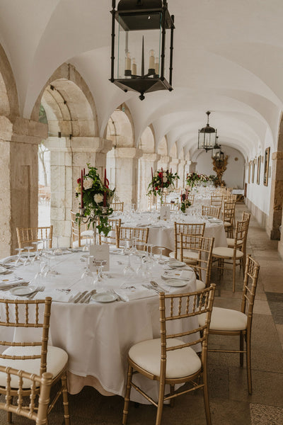 Interior archway of the Pousada Castelo Palmela venue space in Portugal, wedding seating setup.