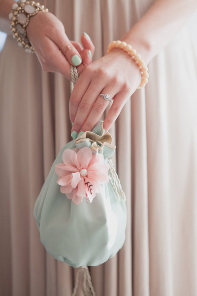 Detail of bride's accessories at garden-themed wedding