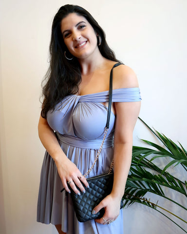 Cruise packing list must-have: Woman wearing Henkaa Dusty Blue Sakura Midi in a trendy off-the-shoulder style perfect for going out on the town.