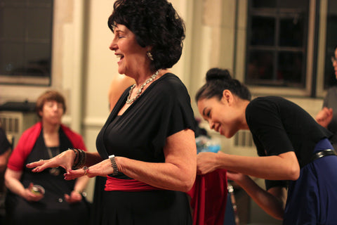 Joanna adjusting a performer's choir outfit before the show