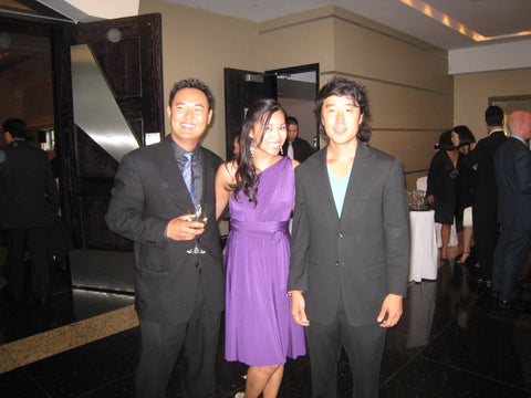 Joanna Duong Chang in Henkaa's first Plum Purple Sakura Midi Convertible Dress standing with two male wedding guests at Sonia's wedding.