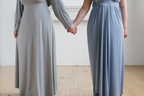 Bridesmaids holding hands wearing Henkaa convertible dresses - a must-have on your bridal checklist