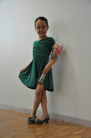 Little girl wearing the Sakura mini wrap dress in emerald green.