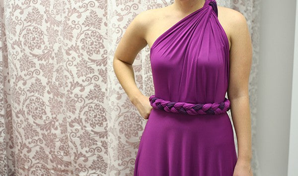 How to wear a sash: woman wearing a magenta purple dress and a sash as a braided strap.