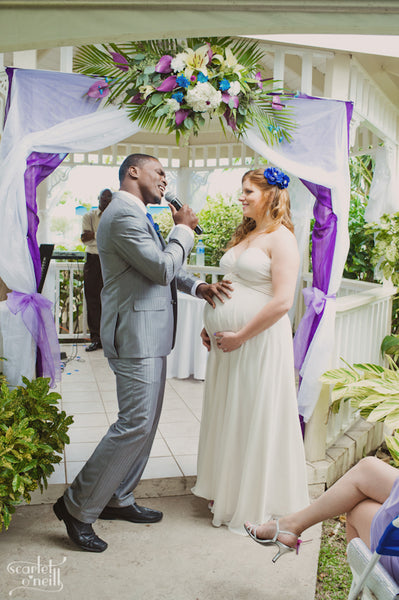 Groom sings to pregnant bride during destination wedding in Saint Lucia.