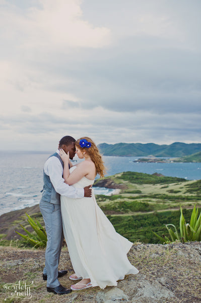 Husband and wife embrace in Saint Lucia after a destination wedding.