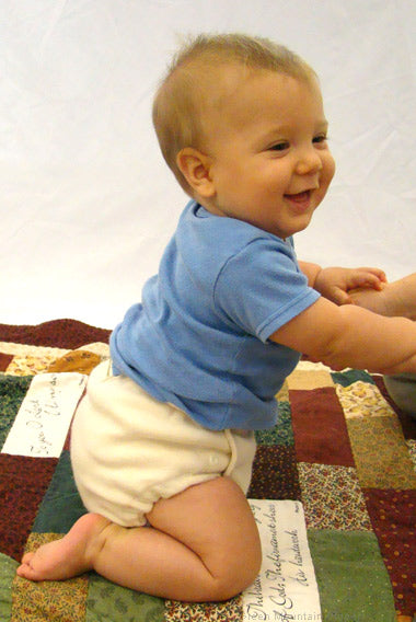 wool diaper cover on smiling baby