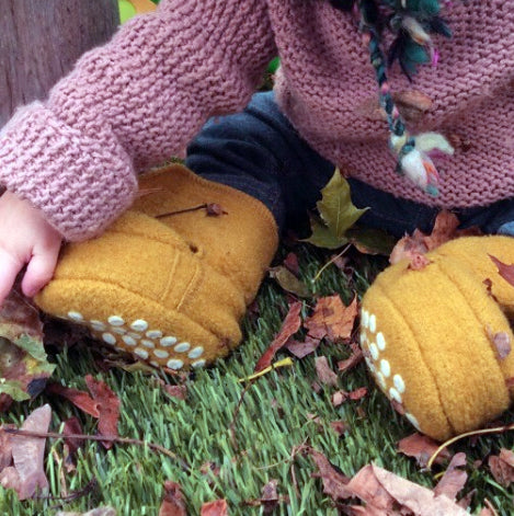 Wool baby booties in curry from Disana