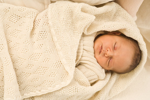 baby in wool blanket