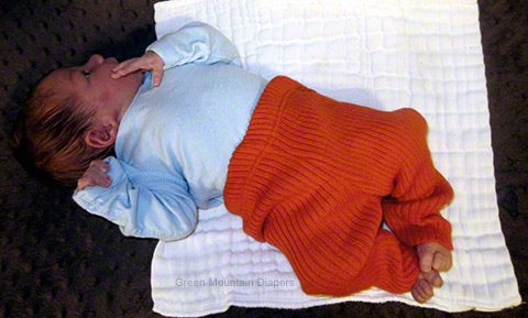 newborn baby in organge Disana leggins size 50-56
