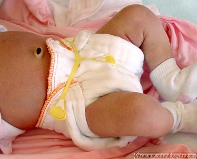 newborn prefold diaper on a baby