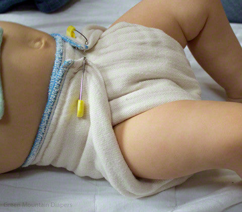 intermediate blue edge prefold diaper on baby