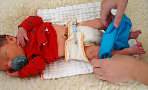 newborn baby in pull on bummis diaper cover