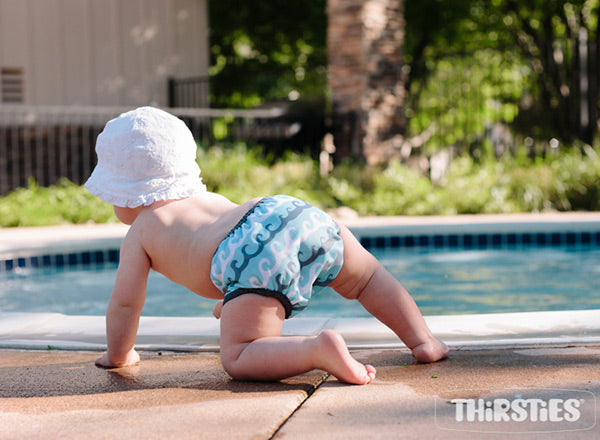 crawling baby in swim diaper