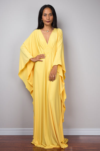 Yellow kaftan dress. Large loose fit dress with plunging neckline in a soft yellow solid fabric. A wide sleeve oversized maxi dress by Nuichan.