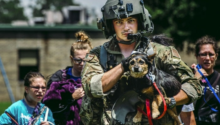 Air Force Senior Airman Austin Helweg leads a Houston family to safety during Harvey Relief Efforts