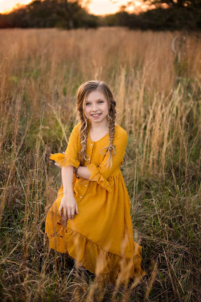 Mara mustard yellow high low dress in field of grass boho photoshoot - Belle & Kai