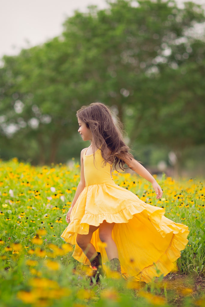 rustic boho yellow high low flower girl dress twirling wildflower child photoshoot