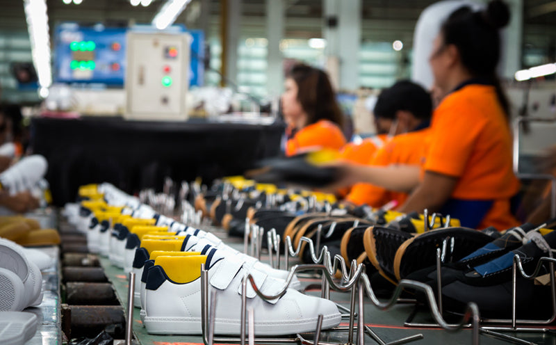 worker making sport shoe production line