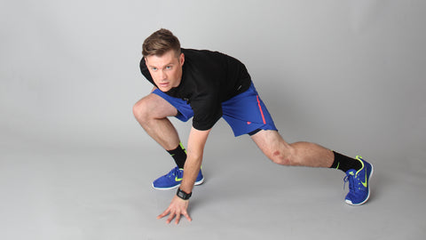 Man doing a side lunge facing forward