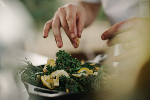 a pair of hands mixing a salad