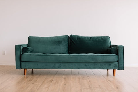 green couch in the middle of a room