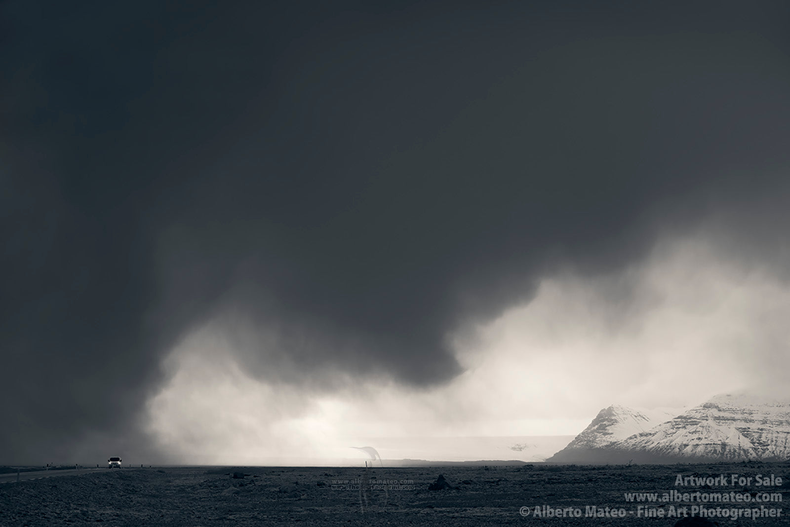 Car under dark storm clouds, near Jokulsárlón, Iceland. 