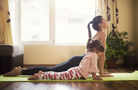 Mom daughter duo doing yoga at home during quarantine