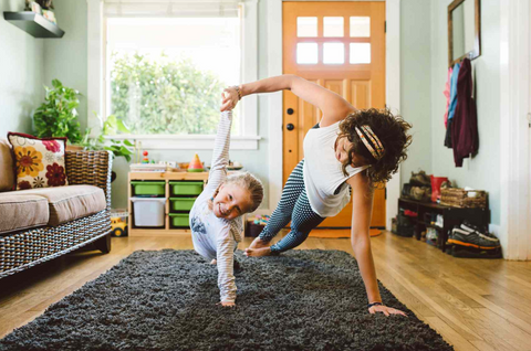 Mother daughter duo doing fun exercises at home