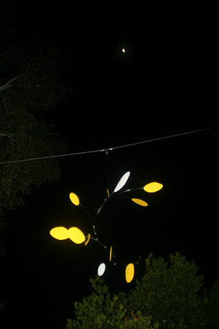 client photo of hanging art mobile by Atomic Mobiles at night with moon in background