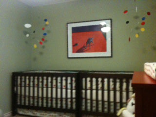 Two hanging mobiles by AtomicMobiles.com in twin baby nursery - photo by client
