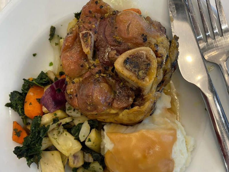 braised pork shank with mashed potatoes and greens and root