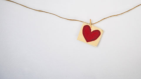 A red paper heart on a string.