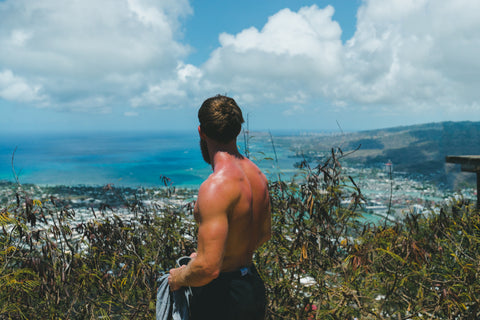 A strong man looking at the water.