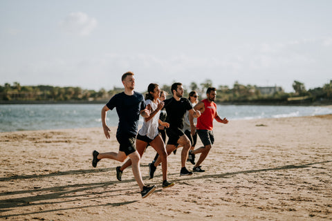 People running on a beach.