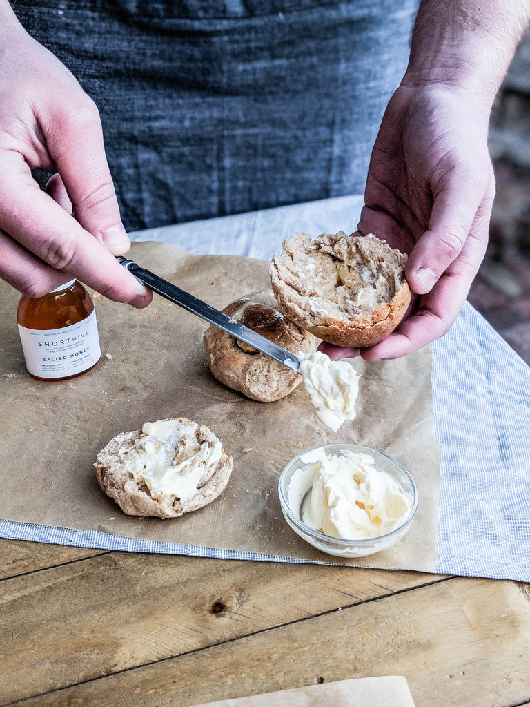 ShortHive Salted (caramel) honey butter being spread onto scones.