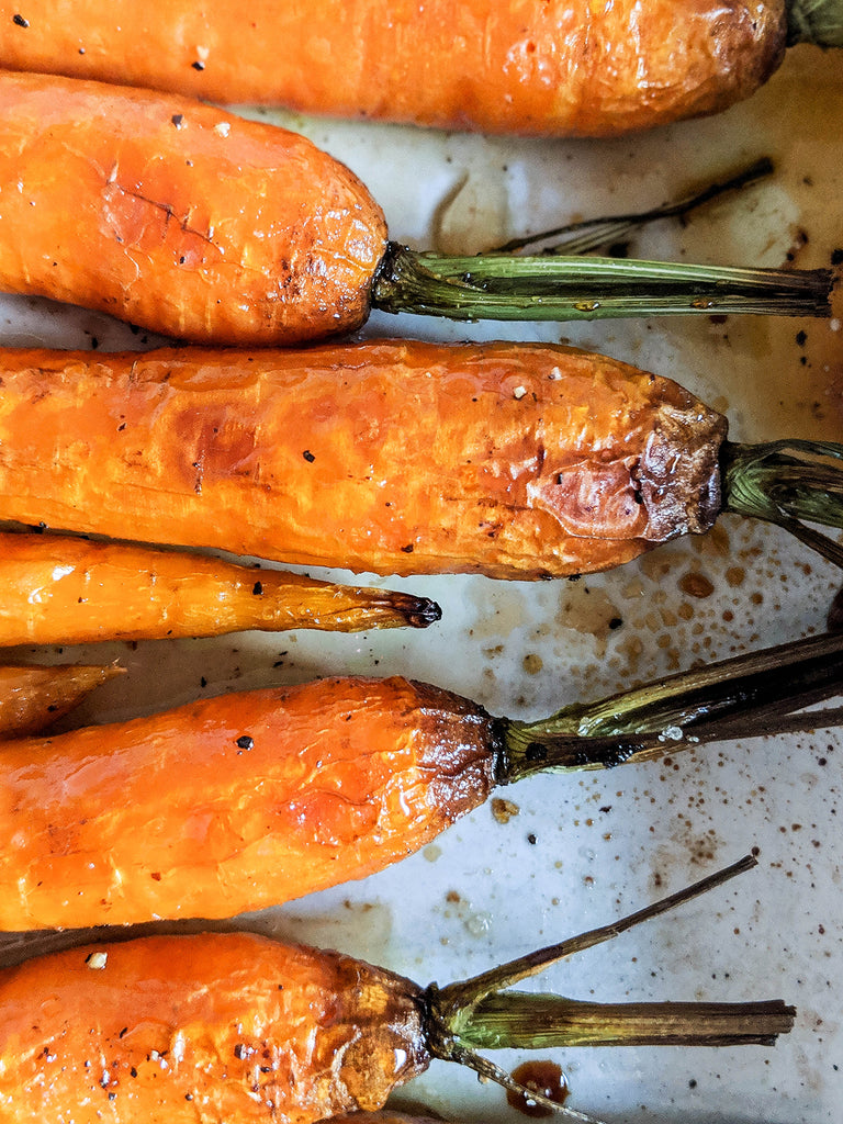 Image showing ShortHive Honey on roasted carrots in a pan.