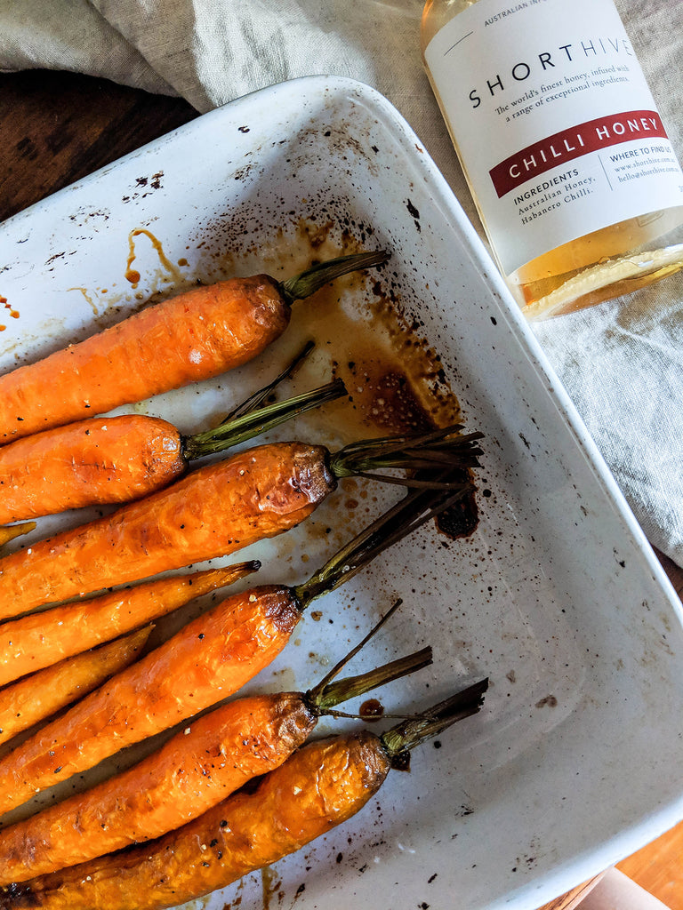 Image showing ShortHive Honey on roasted carrots in a pan.