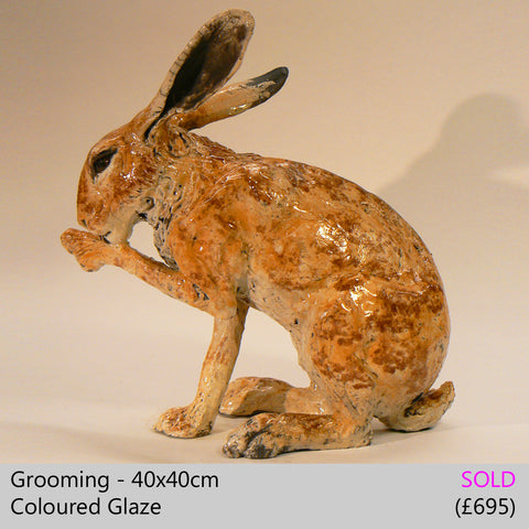 Grooming - raku fired ceramic hare sculpture by Lesley D McKenzie, art and animal sculpture