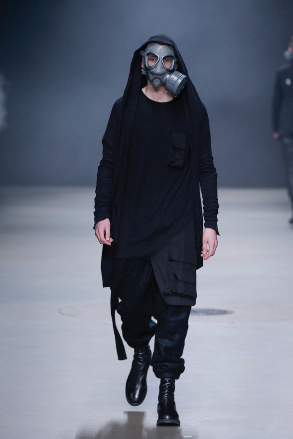 er 2016 Show during Amsterdam's Mercedes Benz Fashion Week. With the continuation of their typical monochrome colour palette, Swedish design duo Daniel Wahlberg and Richard Sjöblom creates yet another arcane collection adding to the mystery with the use of gas masks. Drop-crotch pants, asymmetrical tops, oversized outerwear combine with structured tailored pieces and leather accessories in a variety of wearable yet conceptual forms. The designer duo continues the evolution of their original concept, "combining classic designs from the west with avant-garde fashion from the east."