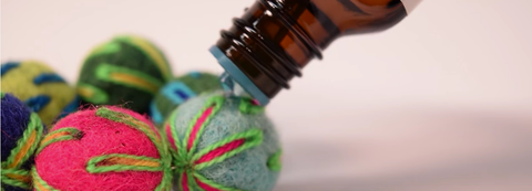 Putting Wonderful Scents Essential Oils On DIY Felt Ball For Aromatherapy