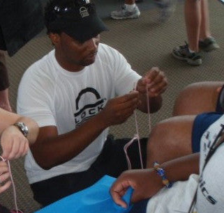 Inventor Eric Jackson laces people up with Lock Laces, original elastic no-tie shoelaces, at a community event!