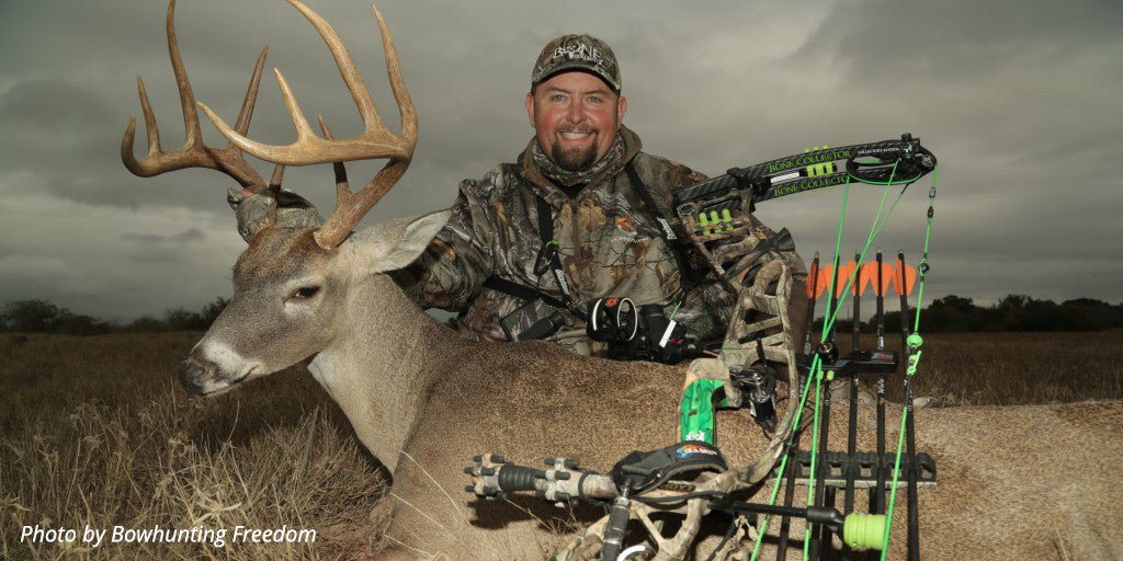 Travis "T-Bone" Turner poses with a buck and his archery equipment after a big hunt.