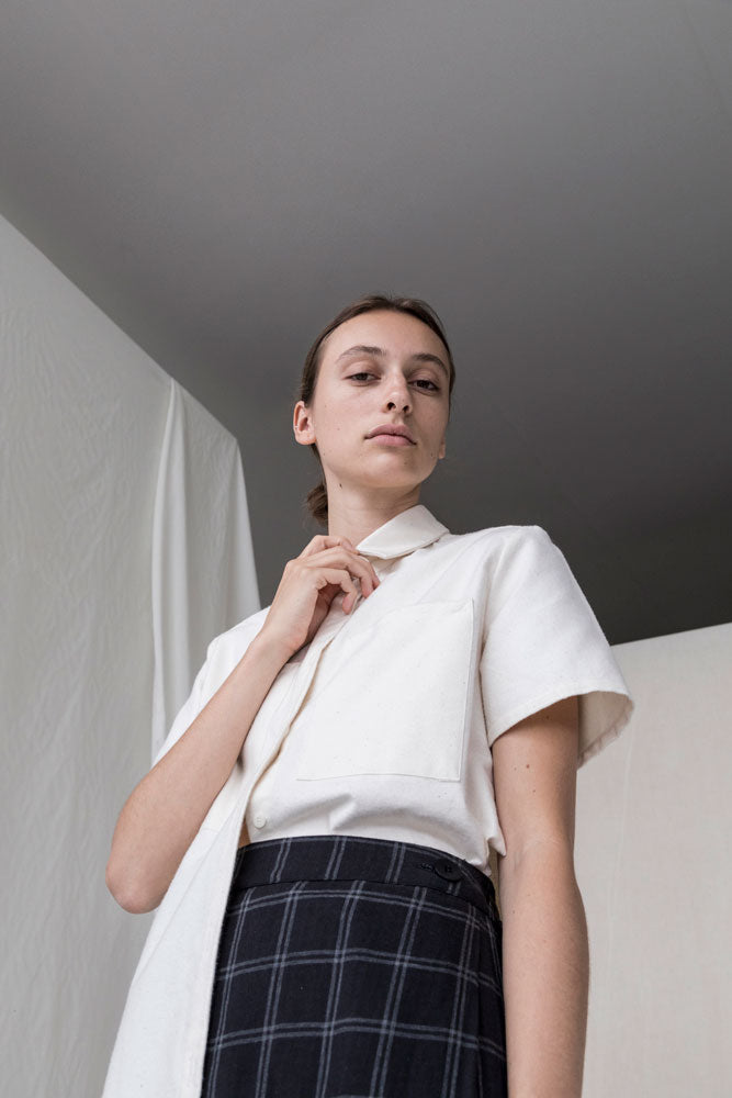 Undyed Shirt on Woman, holding collar