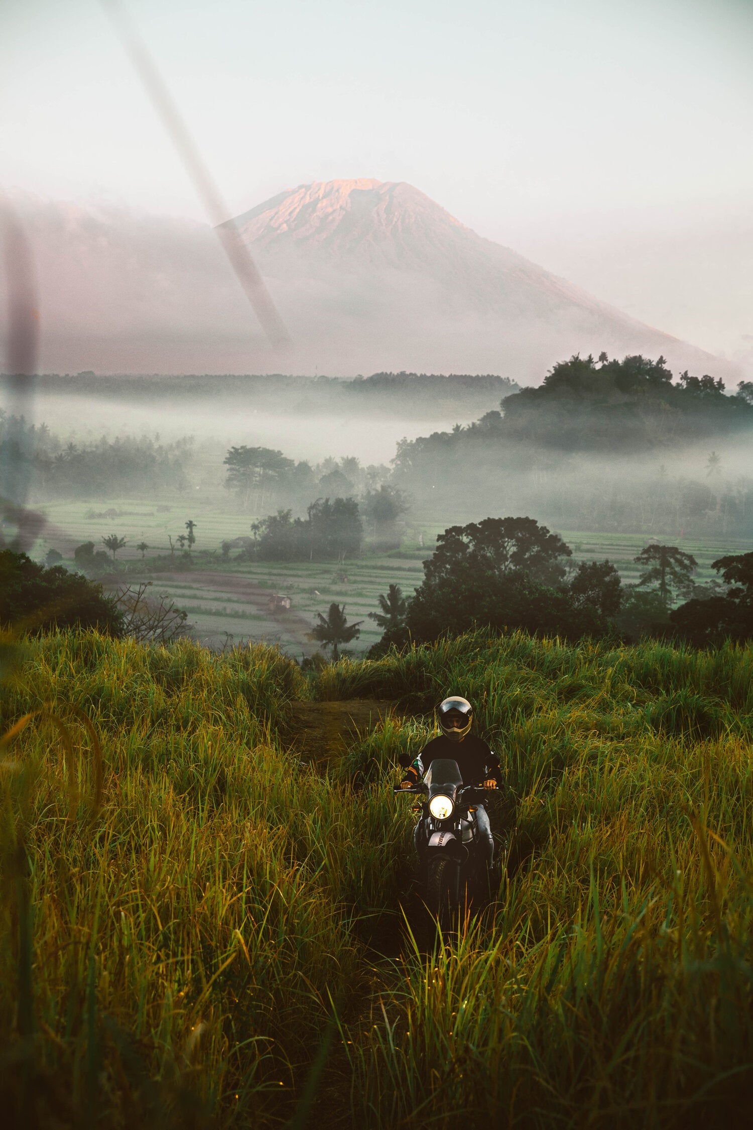 Lost LeBlanc on scooter with Mount Agung in background, Bali