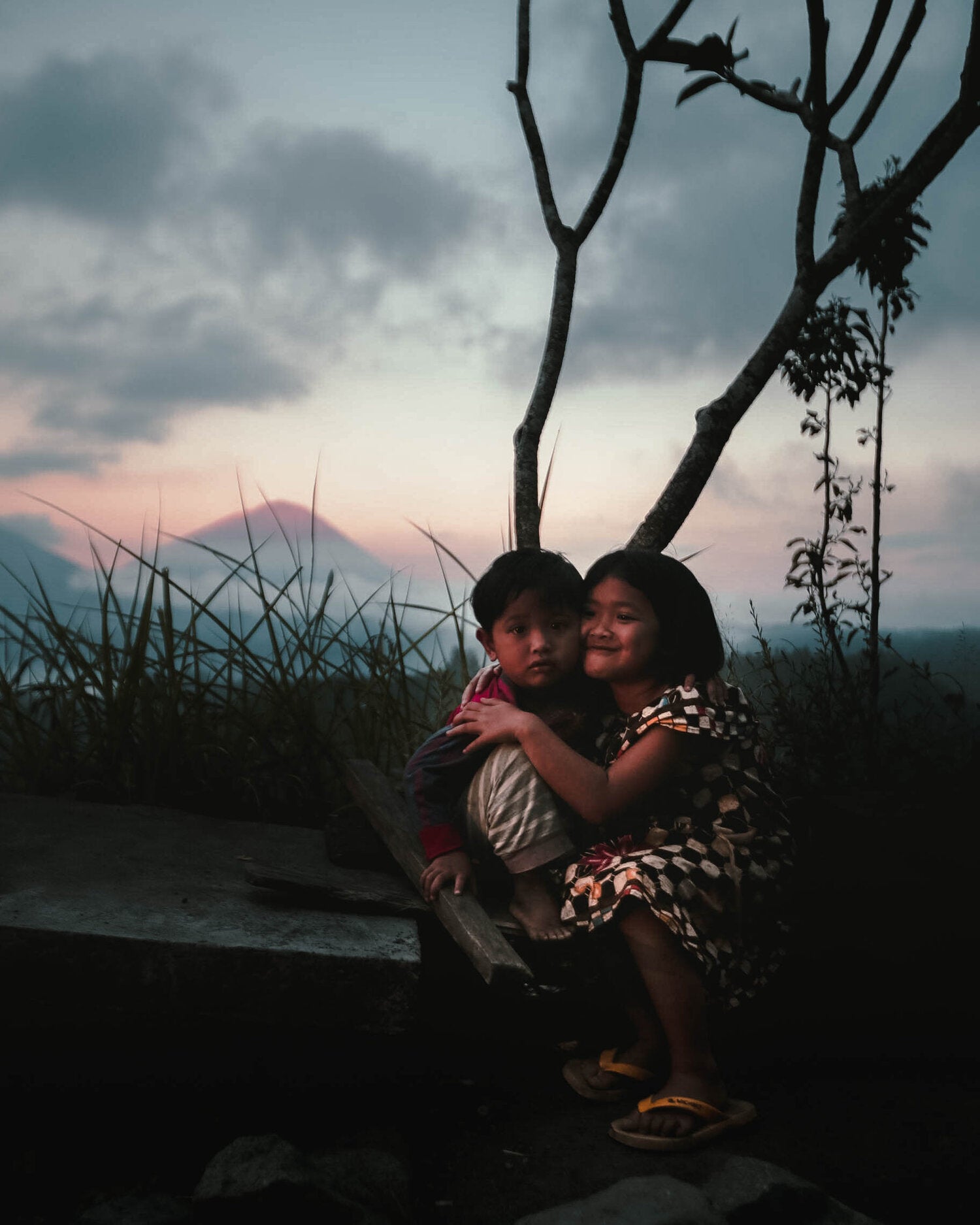 Two Balinese children smiling in front of Mount Agung, Bali